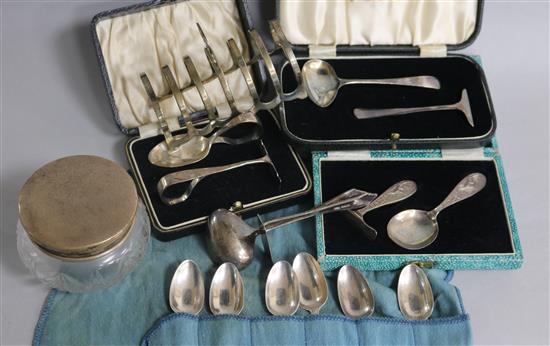 An Edwardian silver toast rack, 4 pairs of childrens feeding pushers, a set of 6 Georgian silver teaspoons and a small lidded jar